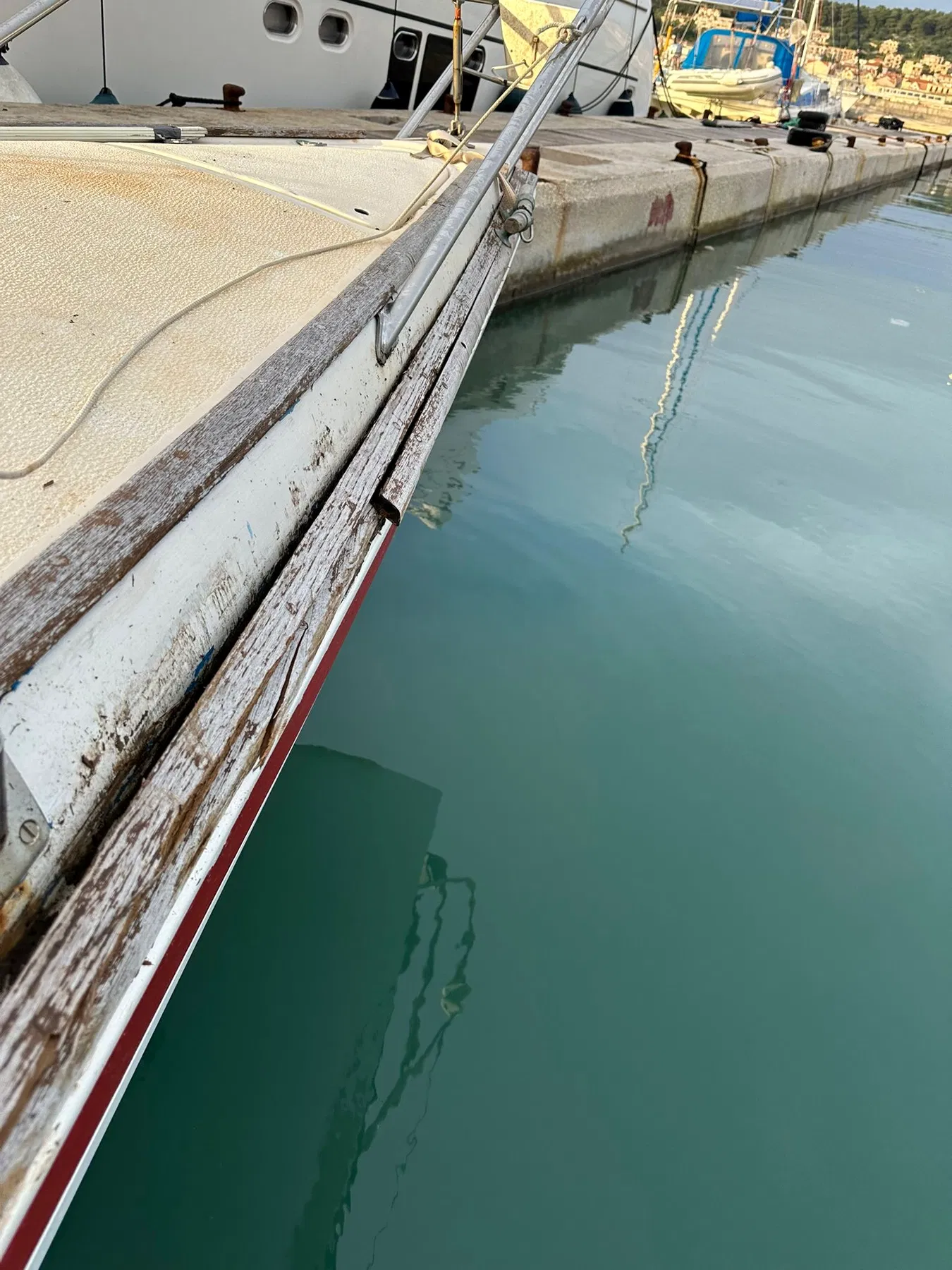 Geschädigtes Boot SANKARA – Blick entlang der hölzernen Kante an Deck beziehungsweise am oberen Rumpfabschluss.